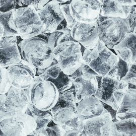 Ice cubes in a close-up shot, glistening and transparent.